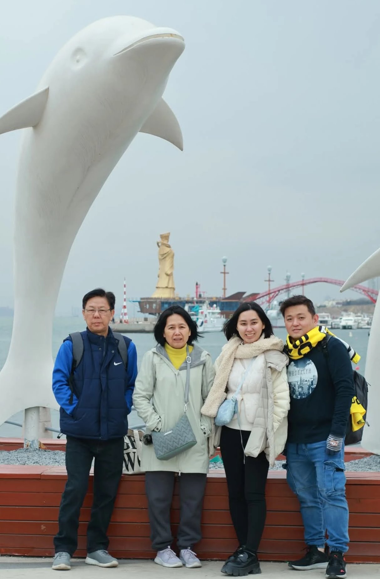 The same visitor group at a Qingdao waterfront landmark